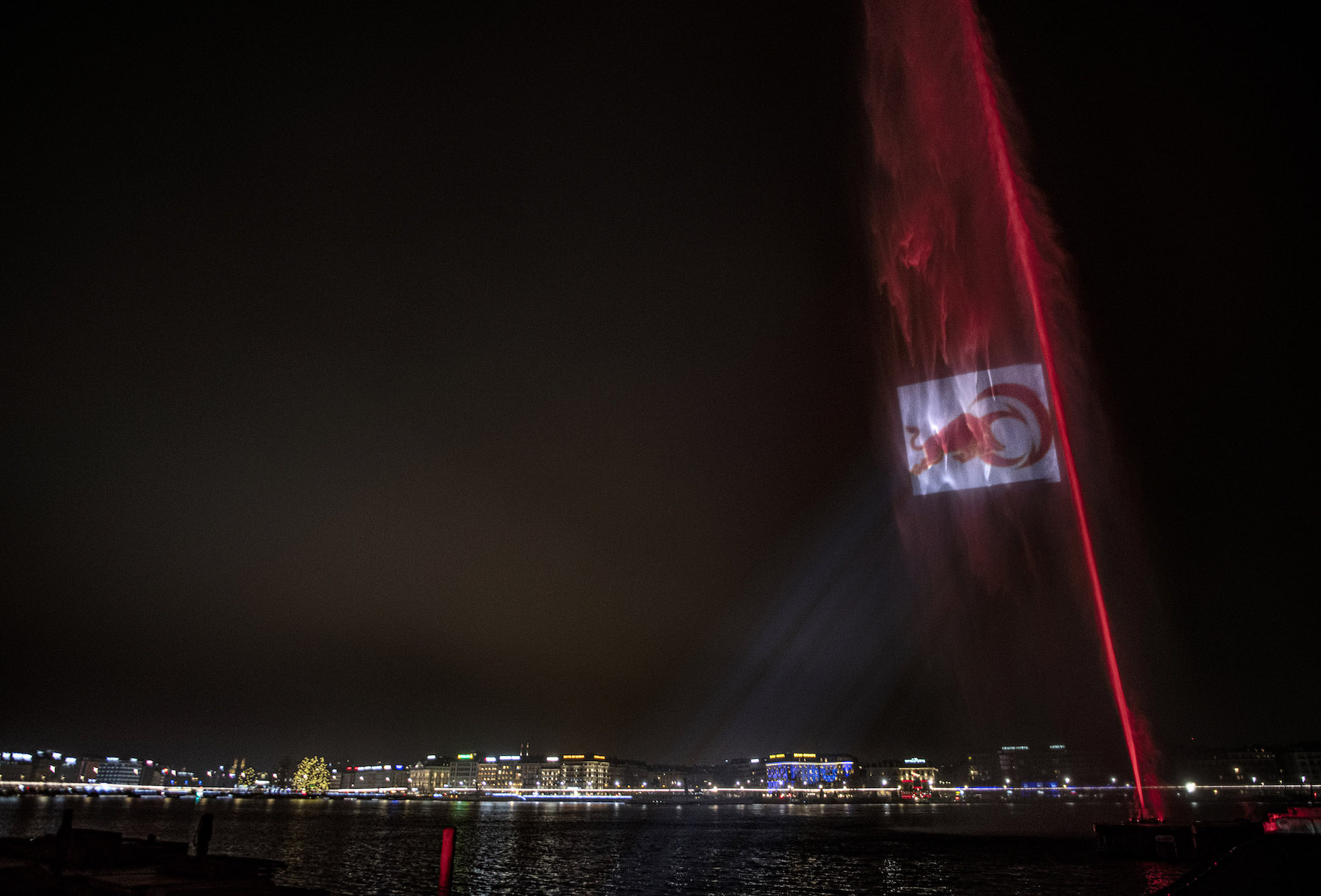 The Alinghi Red Bull Racing logo is seen displayed at the Jet d'eau in Geneva, Switzerland on December 13, 2021