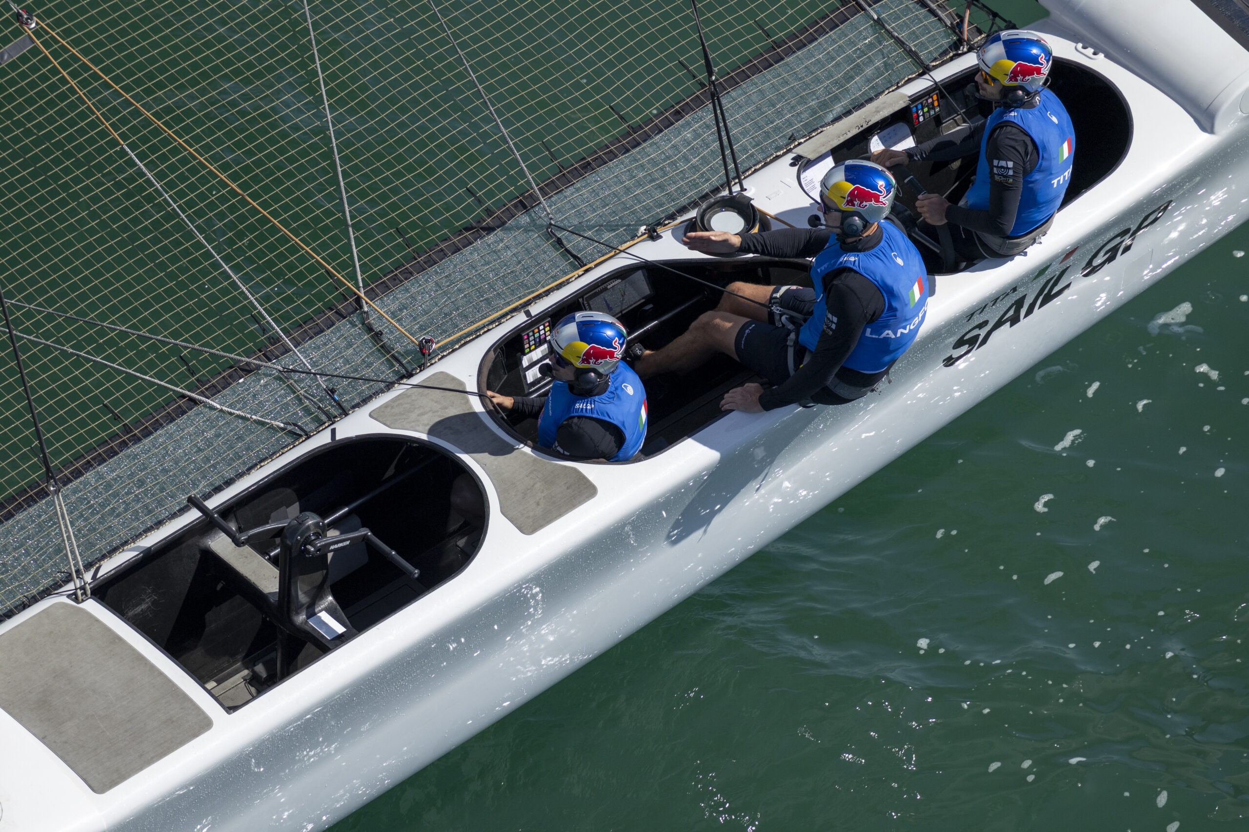 Ruggero Tita, driver of Red Bull Italy SailGP Team controls the wheel alongside Kyle Langford, wing trimmer of Red Bull Italy SailGP Team whilst in action on Race Day 1 of the DP World Spain Sail Grand Prix held in Cadiz, Spain Saturday 4 October 2025. Rolex SailGP Championship Event 11 2025 Season. Photo: Felix Diemer for SailGP. Handout image supplied by SailGP