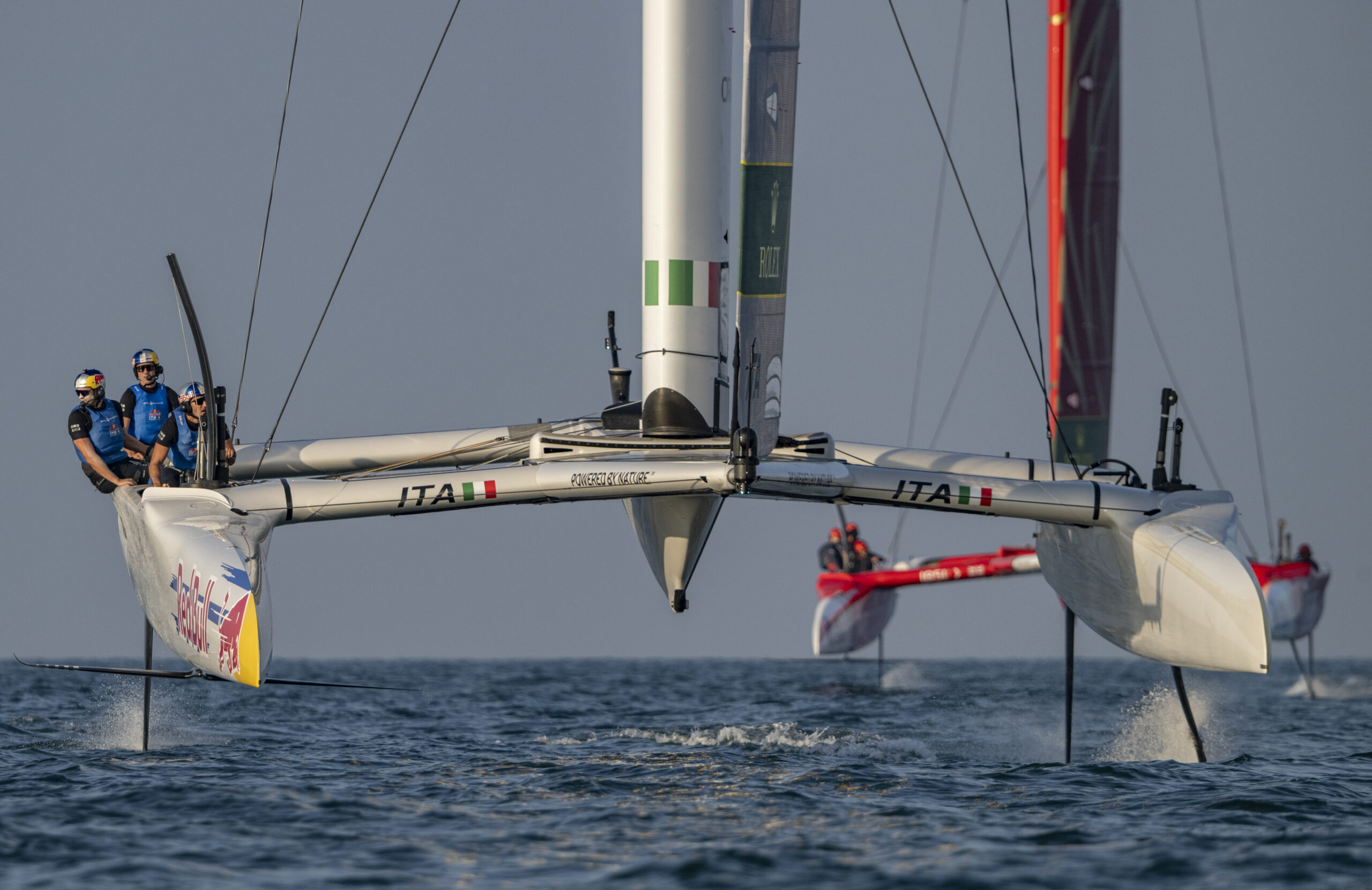 Red Bull Italy SailGP Team helmed by Phil Robertson leads Emirates Great Britain SailGP Team helmed by Dylan Fletcher during a practice session ahead of the Mubadala Abu Dhabi Sail Grand Prix 2025 Season Grand Final presented by Abu Dhabi Sports Council held in Abu Dhabi, United Arab Emirates, Thursday 27 November 2025. Rolex SailGP Championship Event 12 2025 Season. Photo: Ricardo Pinto for SailGP. Handout image supplied by SailGP