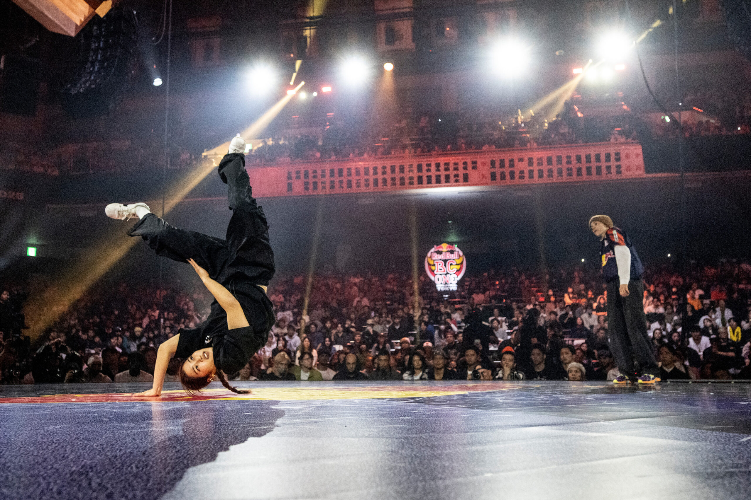 B-girl Riko (L) of Japan competes against Nicka of Lithuania during the Red Bull BC One World Final at Ryogoku Kokugikan Sumo Arena, Tokyo, Japan on November 9, 2025. // Dean Treml / Red Bull Content Pool // SI202511090319 // Usage for editorial use only //