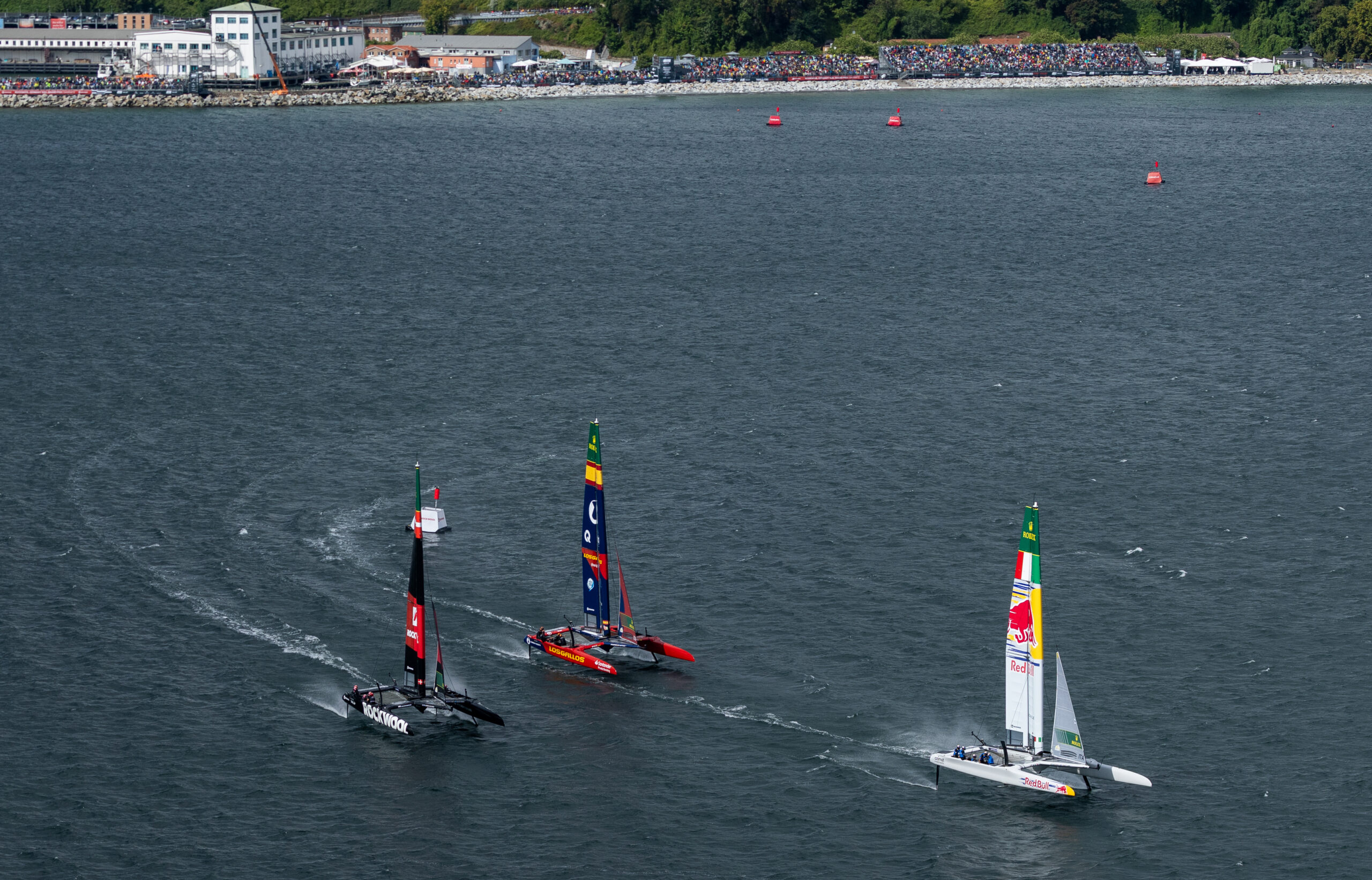 Red Bull Italy SailGP Team driven by Phil Robertson leads ROCKWOOL Racing SailGP Team driven by Nicolai Sehested and Los Gallos SailGP Team driven by Diego Botin on Race Day 2 of the ROCKWOOL Germany Sail Grand Prix in Sassnitz, Germany. Sunday 23 August 2026. Rolex SailGP Championship Event 9 2026 Season. Photo: Felix Diemer for SailGP. Handout image supplied by SailGP