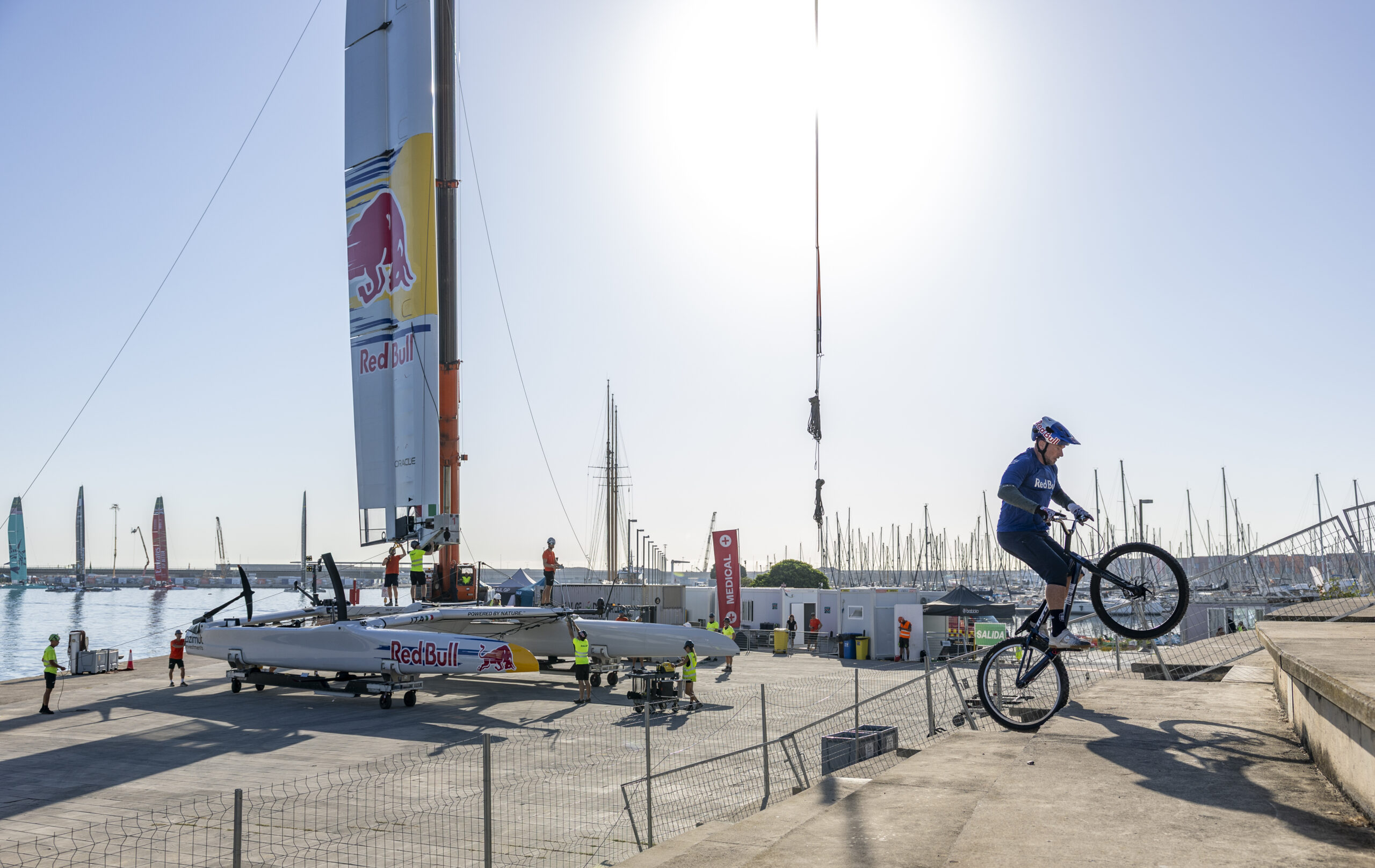 Red Bull ambassador and mountain bike cyclist Kenny Belaey performs BMX stunts in front of the Red Bull Italy SailGP Team F50 as it is prepared in the technical area for racing ahead of the Spain Sail Grand Prix in Valencia, Spain. Friday 4 September 2026. Rolex SailGP Championship Event 10 2026 Season. Photo: Felix Diemer for SailGP. Handout image supplied by SailGP