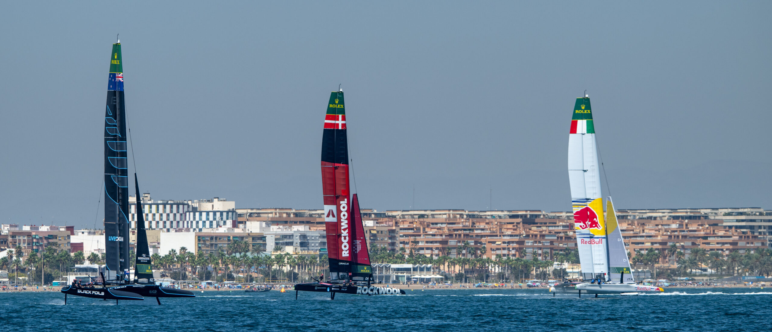 Red Bull Italy SailGP Team ahead of ROCKWOOL Racing SailGP Team and Artemis SailGP Team sailing past the beachfront during a practice session ahead of the Spain Sail Grand Prix in Valencia, Spain. Friday 4 September 2026. Rolex SailGP Championship Event 10 2026 Season. Photo: Ricardo Pinto for SailGP. Handout image supplied by SailGP